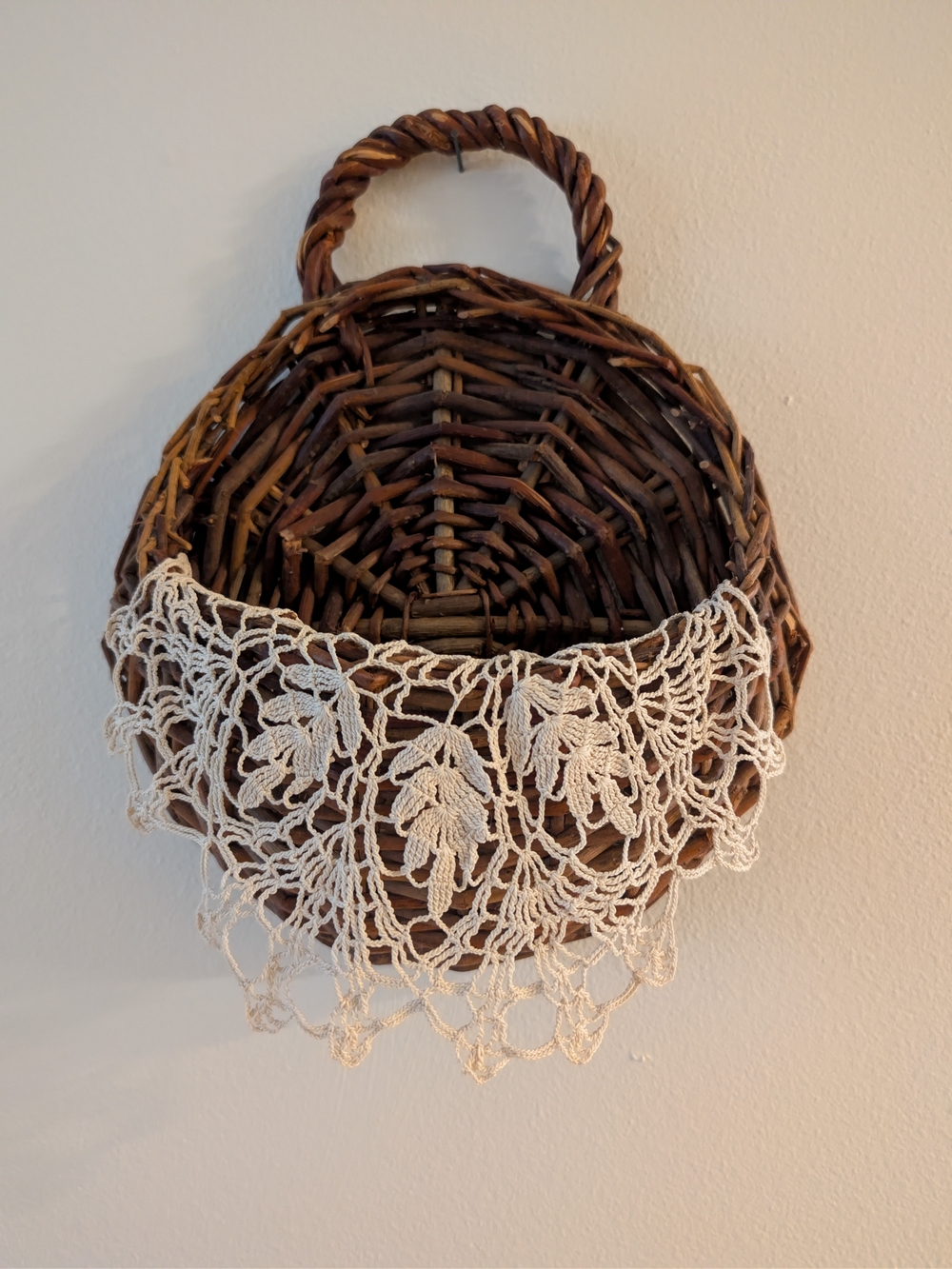 Handwoven Brown Wicker Wall Basket with Vintage Doilie